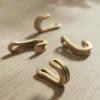 Four Small Brass Hooks